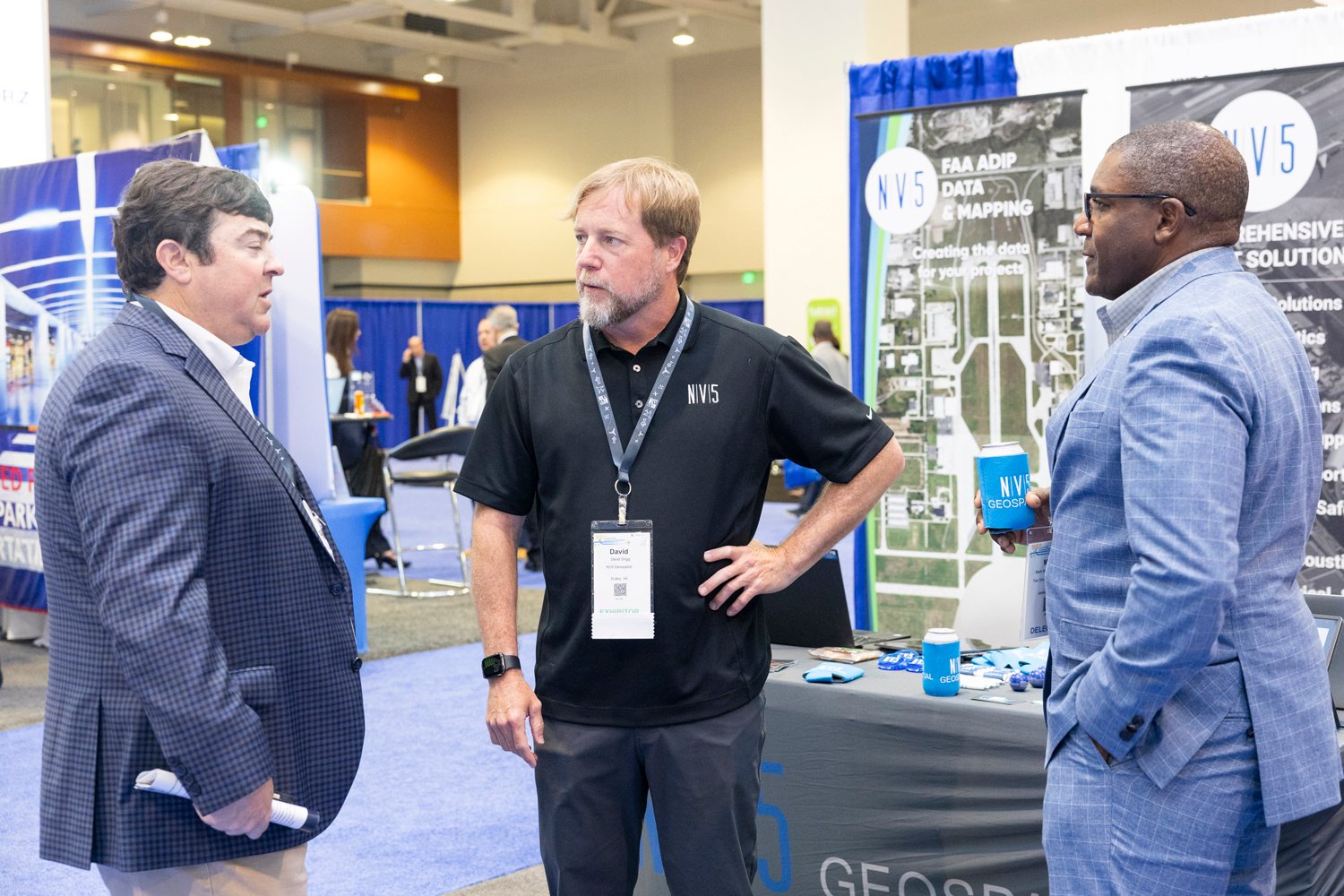 A photo of three men having a conversation in the exhibit hall at the 96th Annual Conference & Exposition in Nashville.