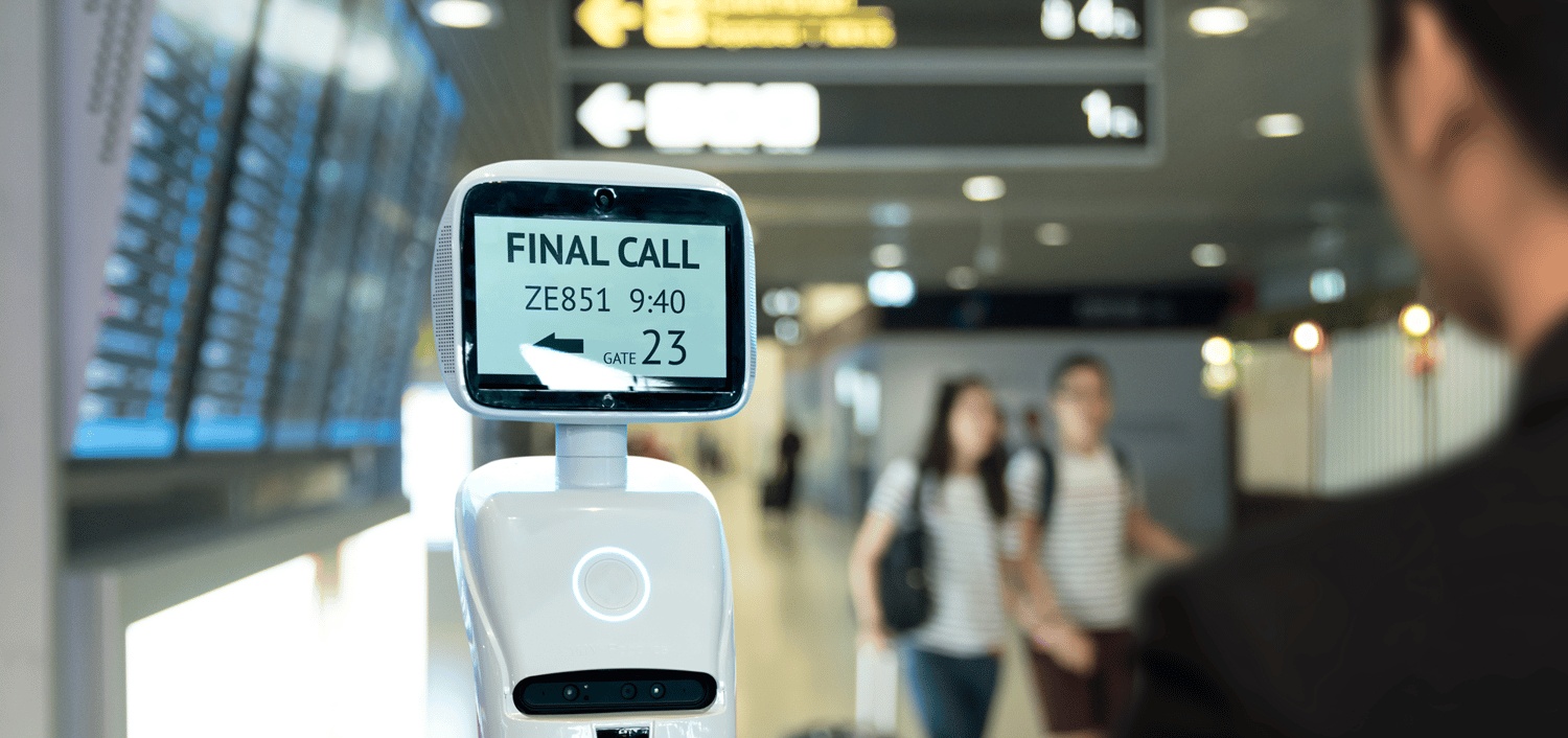 Person using robot in airport to check in to flight Person using robot in airport to check in to flight