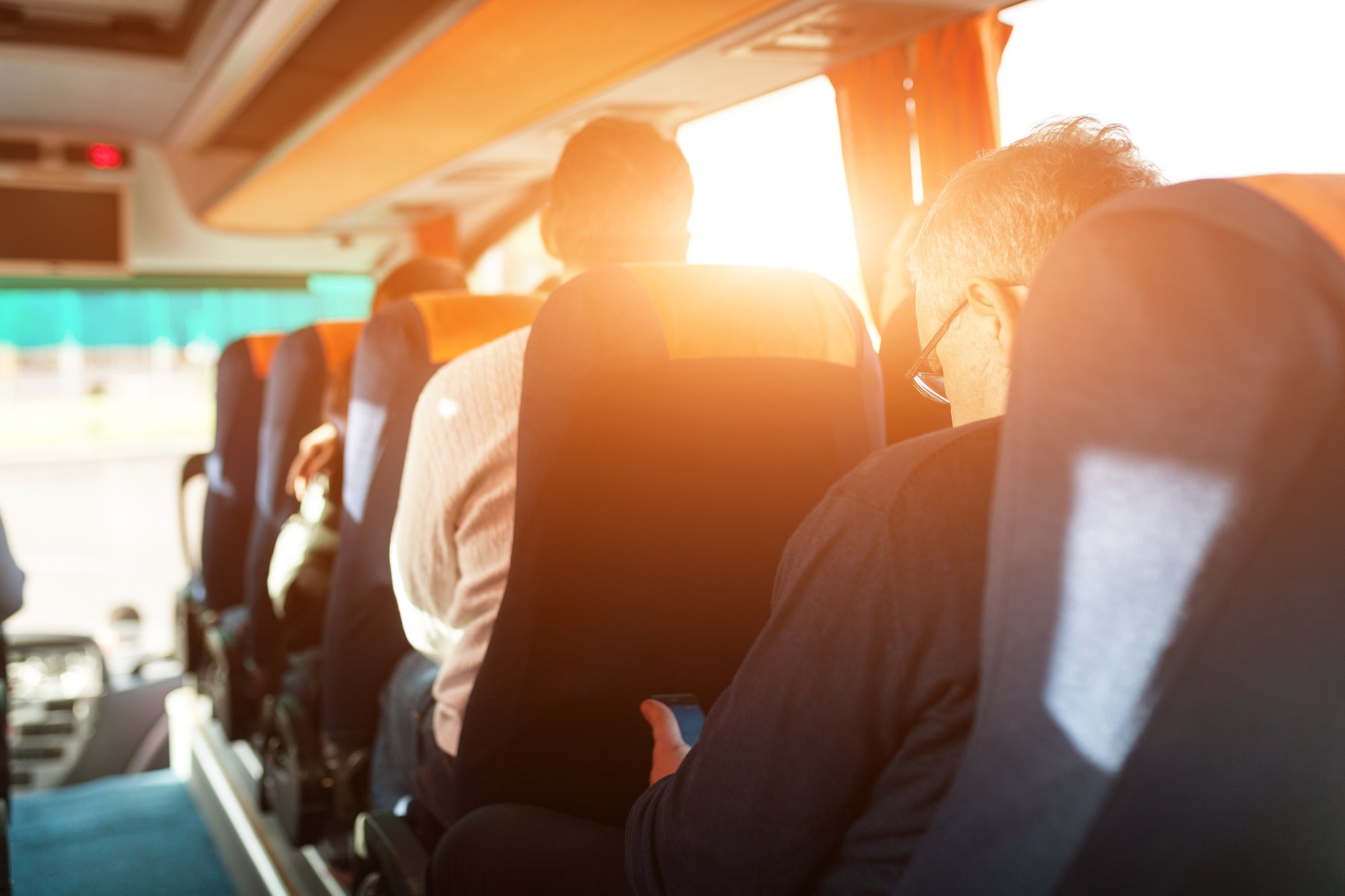 Interior of bus with passenger rear view